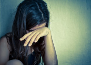 A close up of a teen girl covering her face with her arm. This could represent the pain therapy for teens in South Jersey can offer support with. Learn more about therapy for anxiety in South Jersey by contacting a therapist for teens in Swedesboro, NJ. We offer therapy for teens in Mickleton, NJ and other services. 08028 | 08056