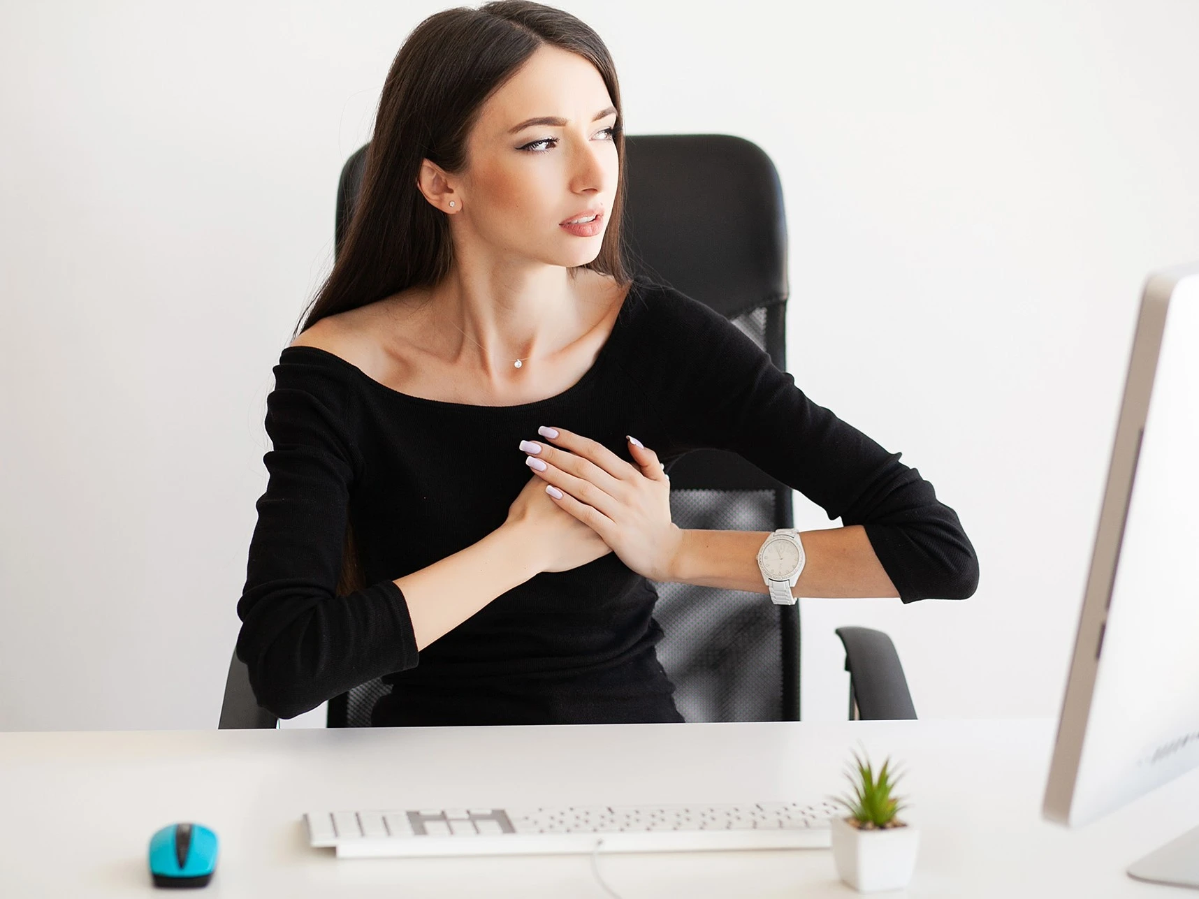 a woman sitting at a desk in front of a computer