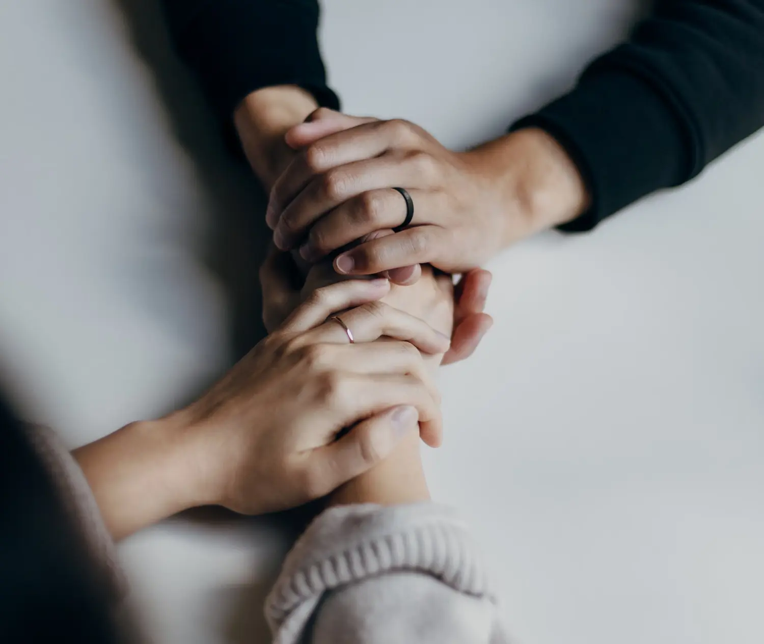 a close up of two people holding hands