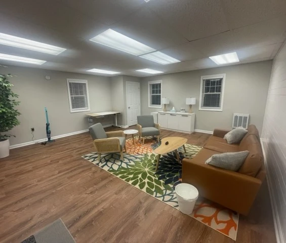 a living room with a couch, chairs and a coffee table