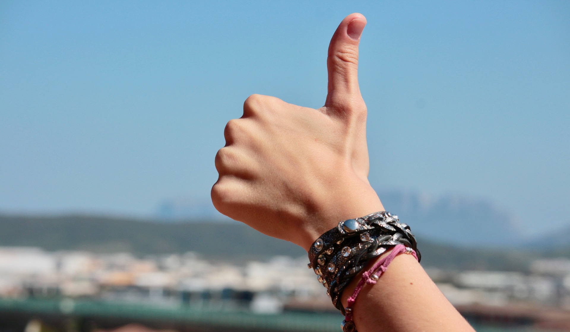 a person's hand with a bracelet on it