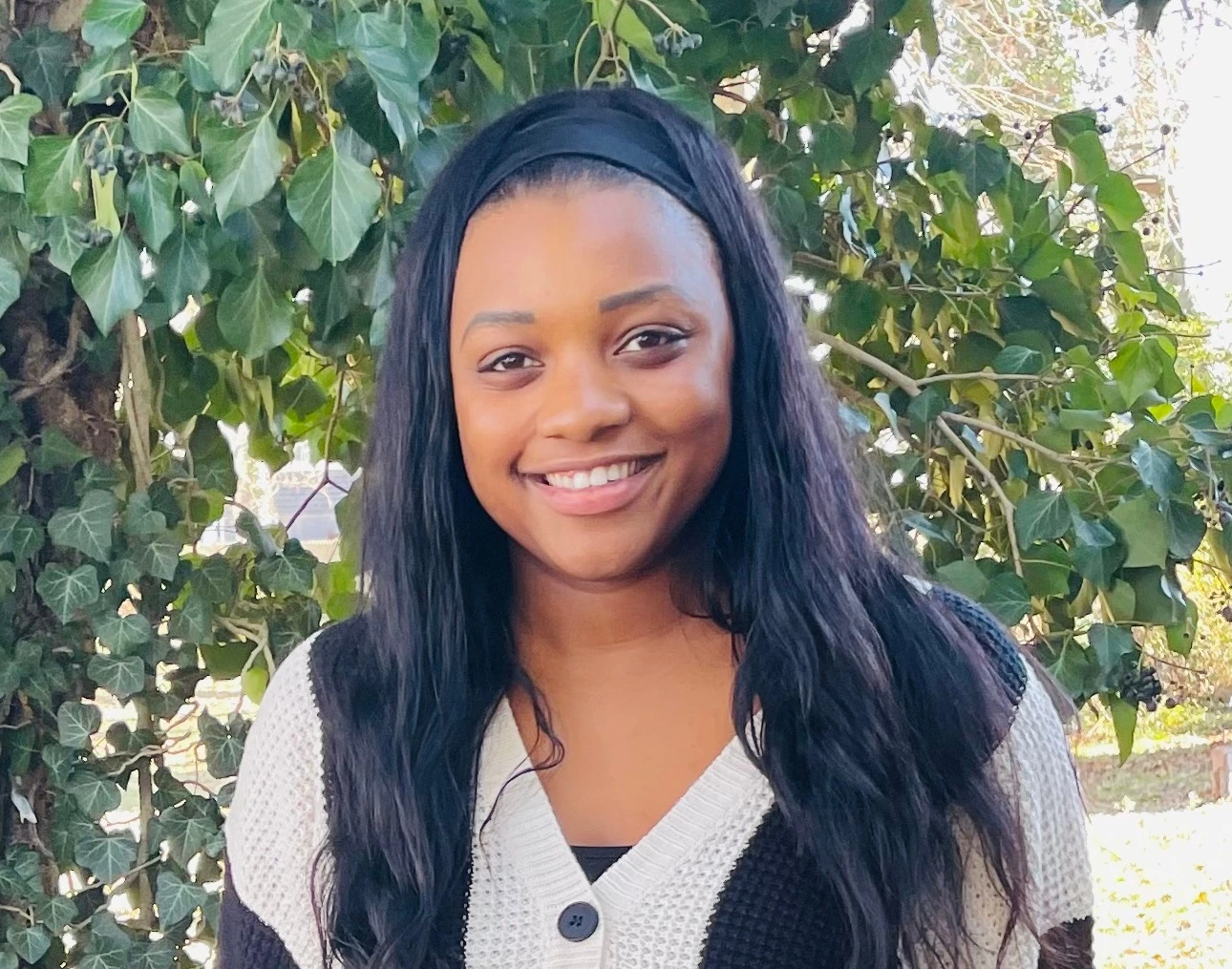 a woman named Kaylin Dixon standing in front of a tree