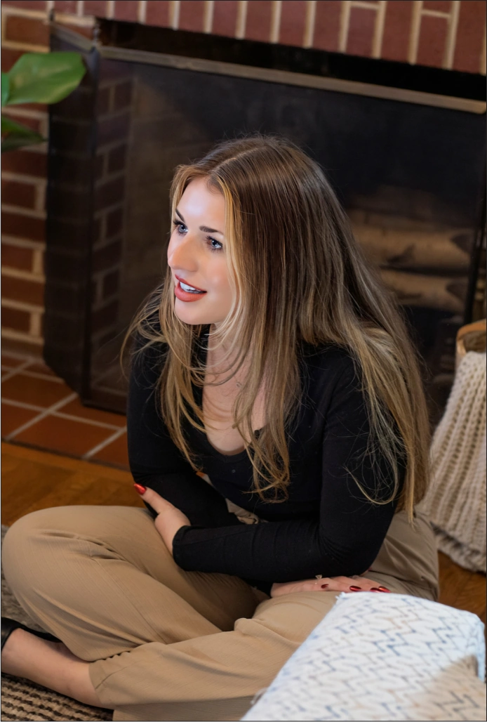 a picture of a woman sitting on a floor