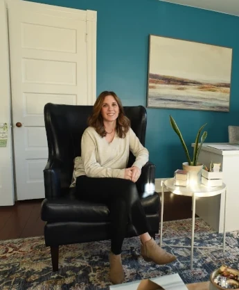 a woman sitting in a chair in a living room