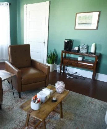 a living room with a couch, chair, and coffee table