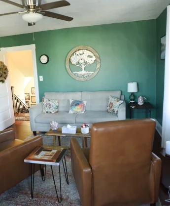 a living room filled with furniture and a ceiling fan