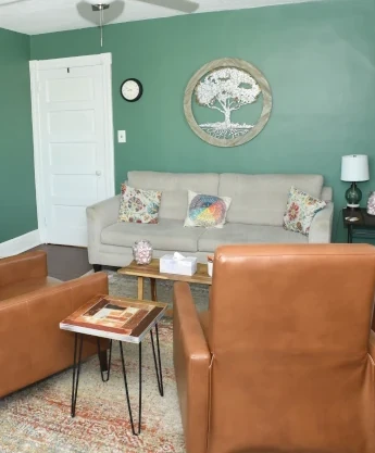 a living room filled with furniture and a ceiling fan