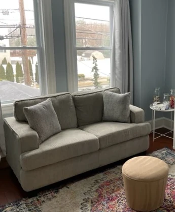 a living room filled with furniture and a large window