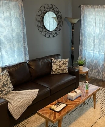 a living room filled with furniture and a mirror