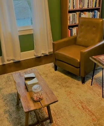 a living room filled with furniture and a book shelf