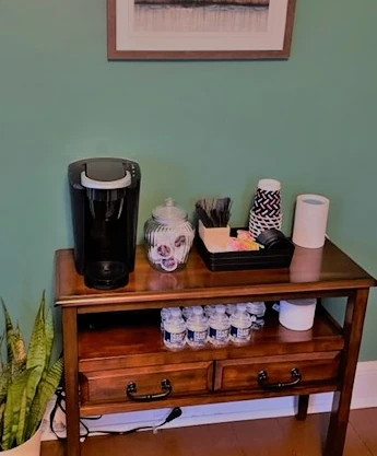 a wooden table with a coffee maker on top of it