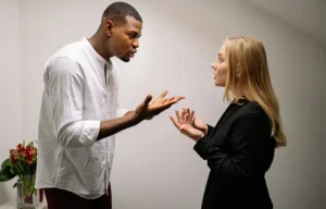 a man standing next to a woman in a room