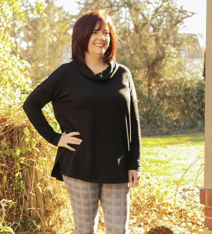 a woman named Kristine Fredericksdorf with red hair and a black hoodie