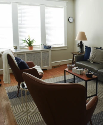 a living room filled with furniture and a lamp