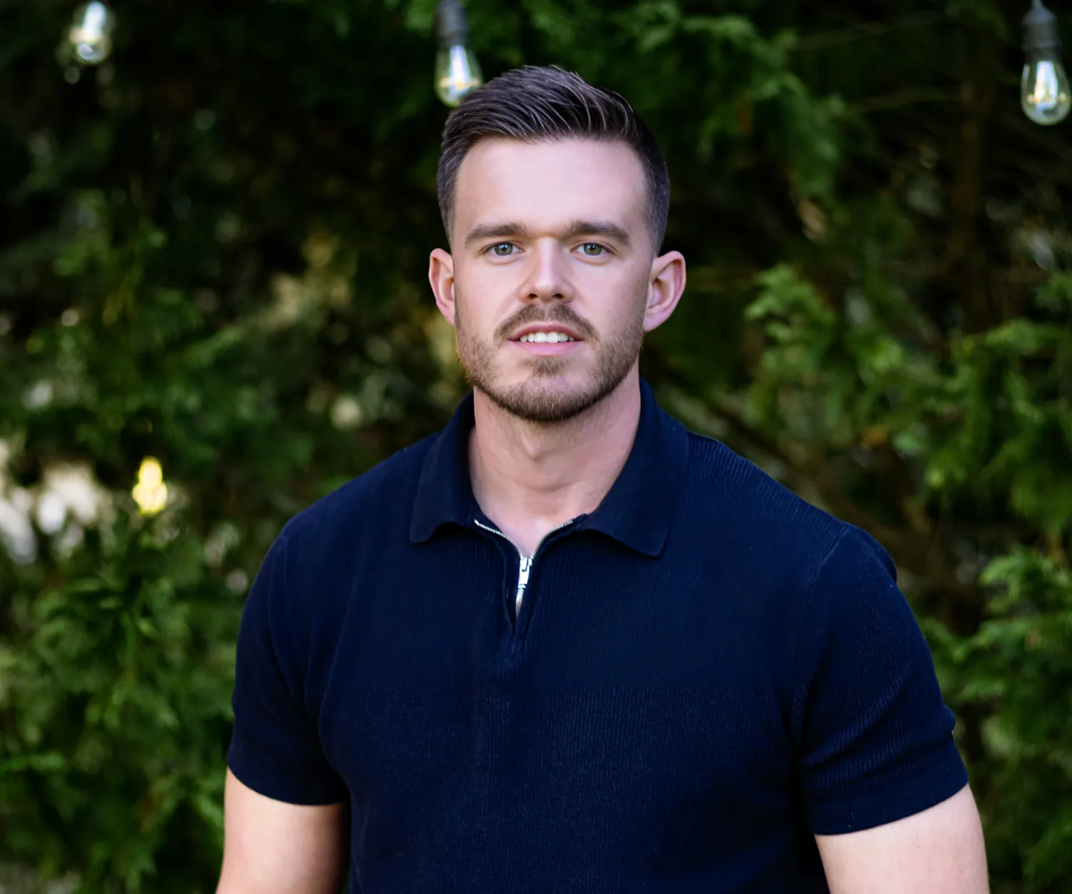 an image of a man wearing white blue shirt smiling for the camera