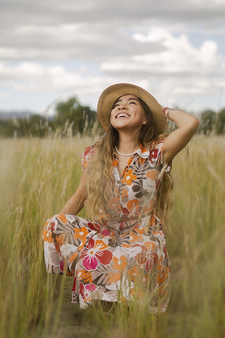 Smiling woman with a dress in a field